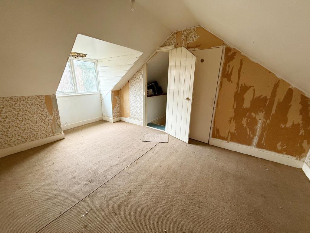 Lot: 111 - ESTABLISHED FOUR-BEDROOM TERRACE HOUSE FOR IMPROVEMENT - Attic Bedroom with window to the rear